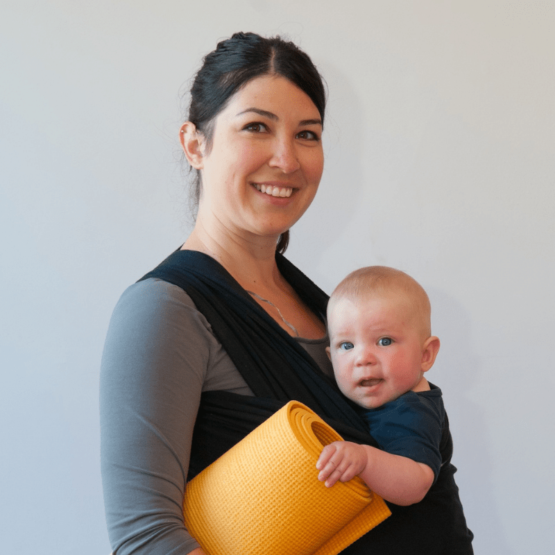 A woman holding a baby in her arms.