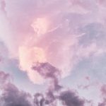 A pink cloud is in the sky with purple clouds.