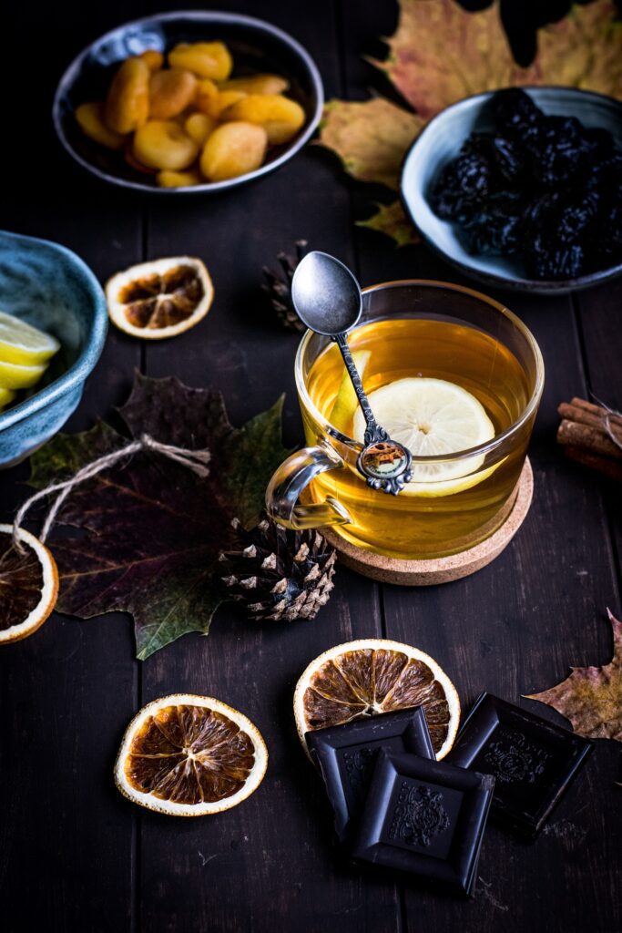 A cup of tea on the table with other food